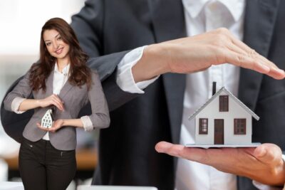 Une femme et un homme présentent leurs offres d'assurance pour biens immobiliers